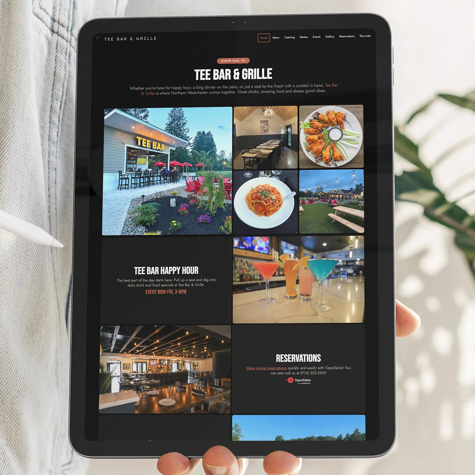 Tablet screen showing Tee Bar & Grille website with images of outdoor seating, food dishes, drinks, and restaurant interiors.