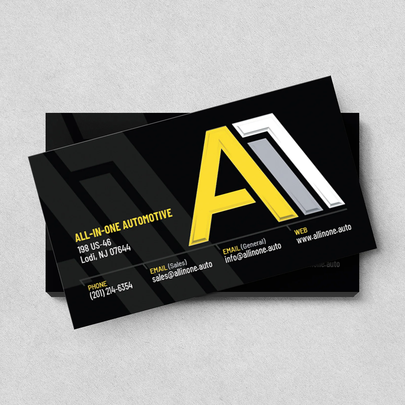 All-In-One Automotive business card with contact information and a large yellow and white A11 logo on black background.
