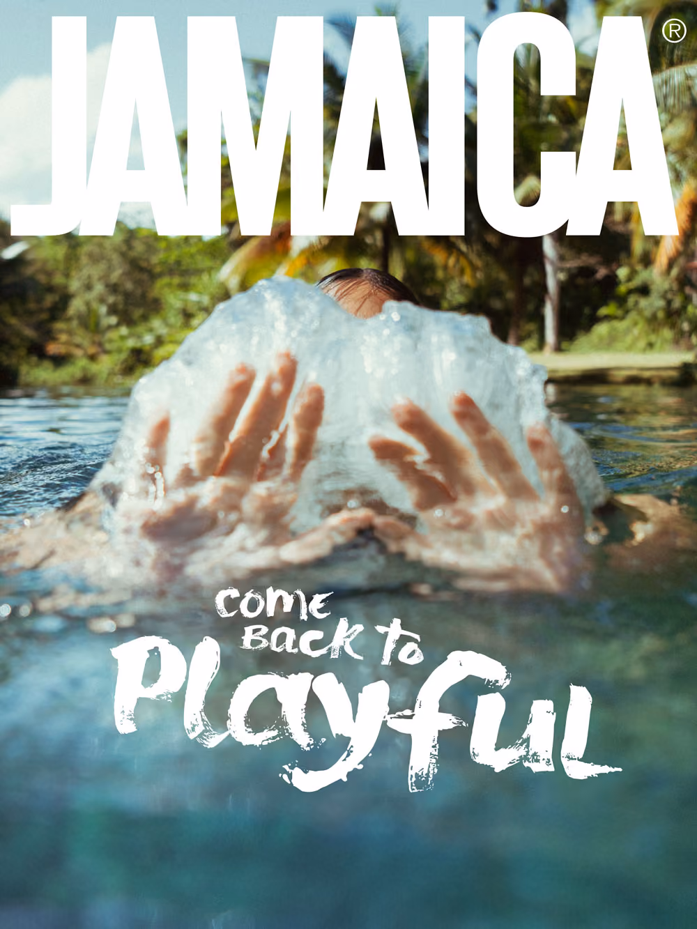 Person in water splashing water with hands, with text Jamaica and come back to playful.