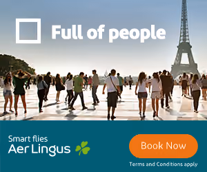 Crowd of people with the Eiffel Tower in the background and an Aer Lingus booking ad.