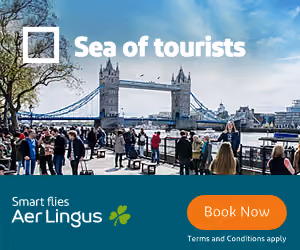 Crowd of tourists near Tower Bridge in London on a sunny day, with Aer Lingus ad overlay.