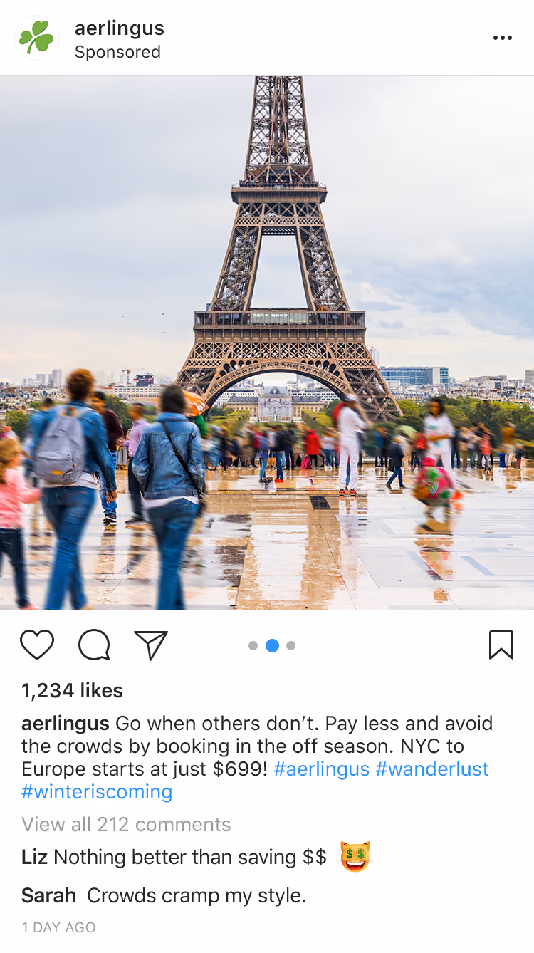 Crowds of people walking near the Eiffel Tower on a cloudy day with reflections on wet pavement.