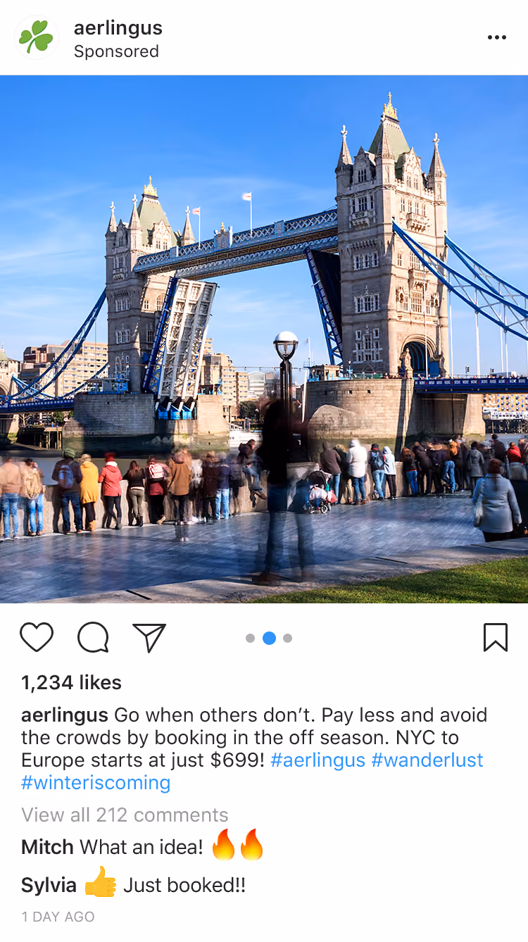 Tower Bridge in London raising its bascules with crowds watching along the riverbank on a clear day.