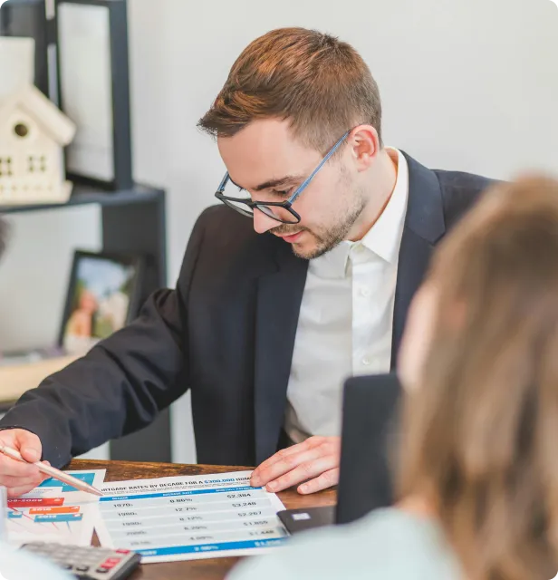 A dedicated male real estate agent from Royal LePage Sarnia-Lambton, diligently working at his desk to ensure a smooth and successful transaction for his clients.