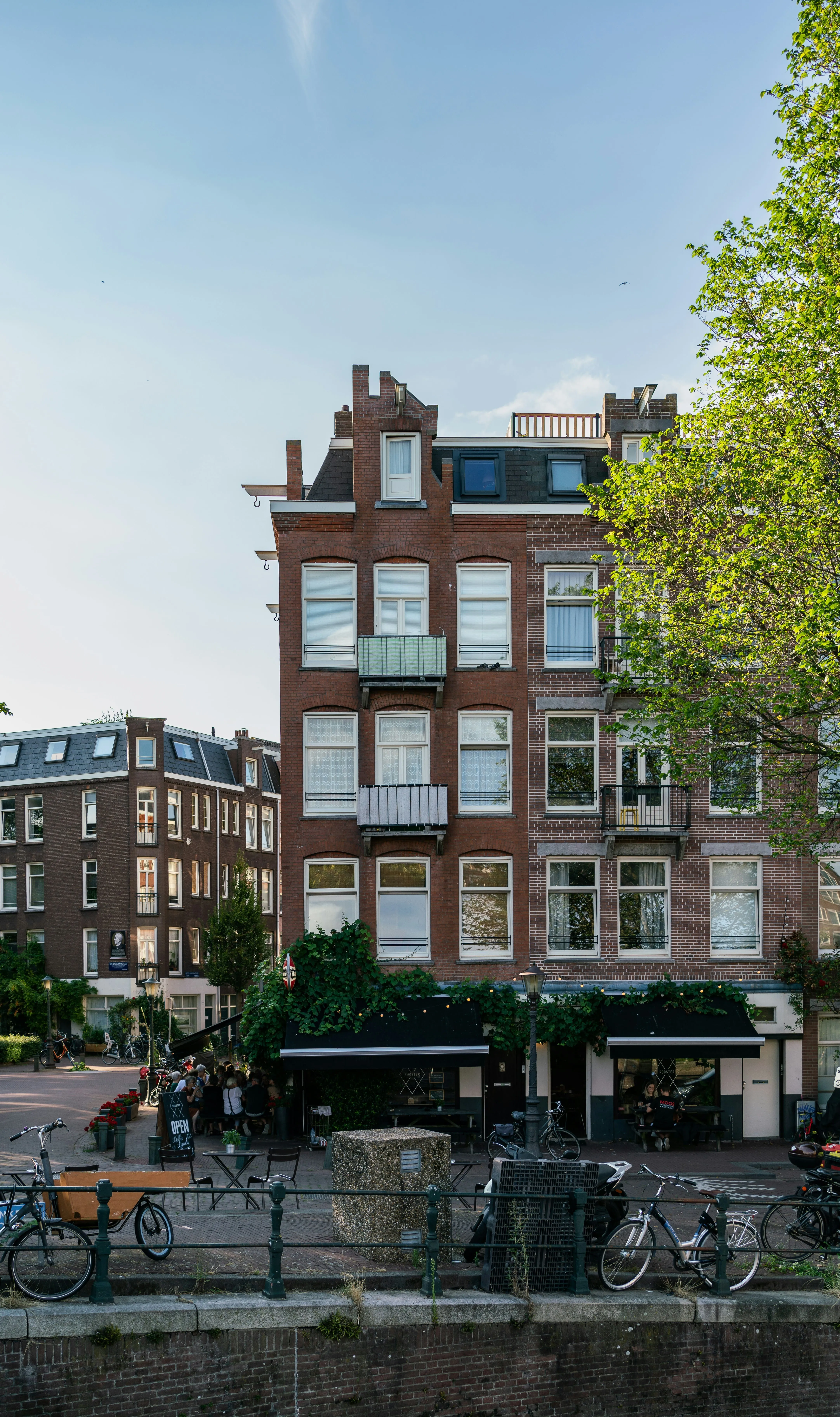 tall amsterdam buildings with bikes in the foreground