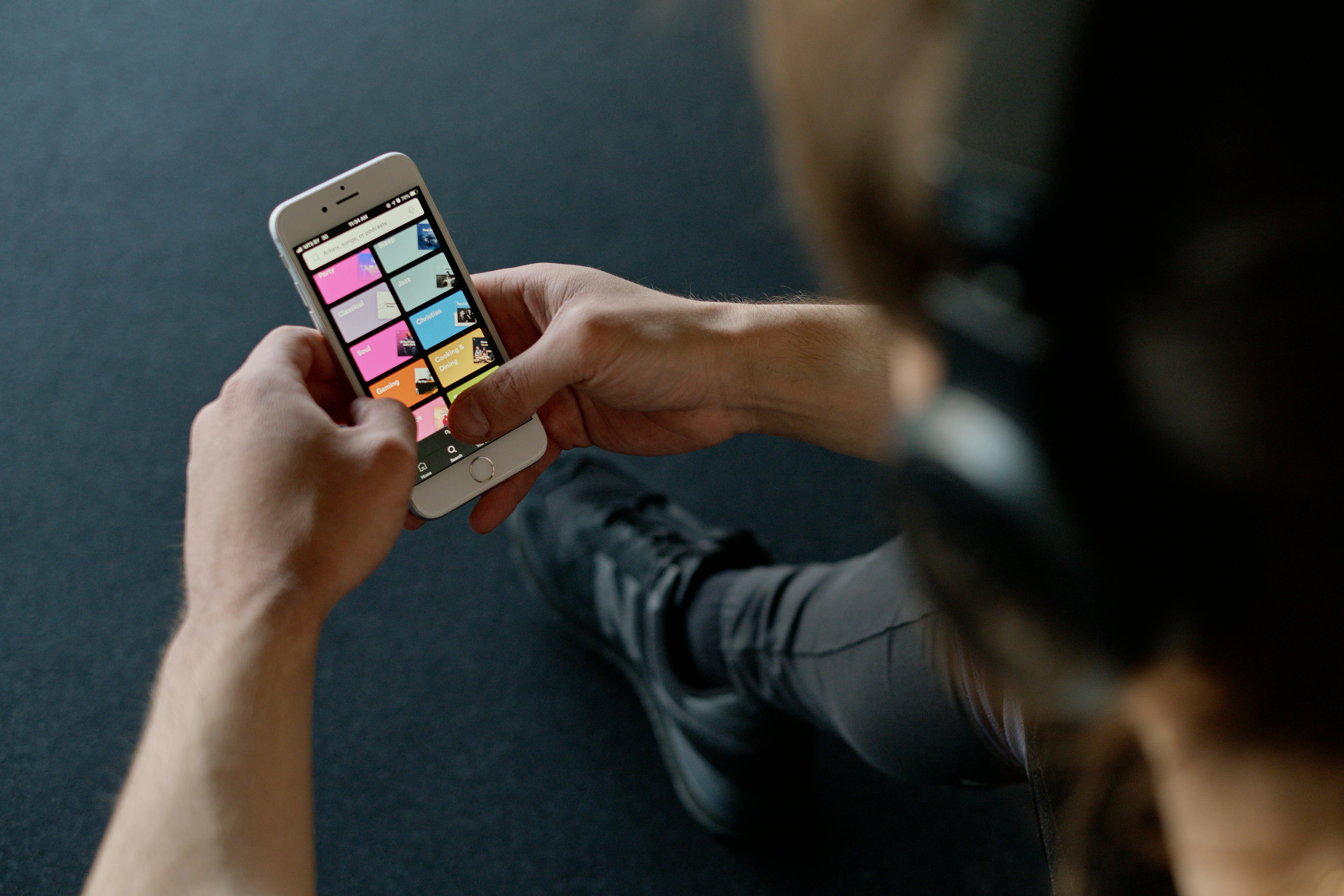 A  person browsing Spotify's big grids. The menu icons are very small.