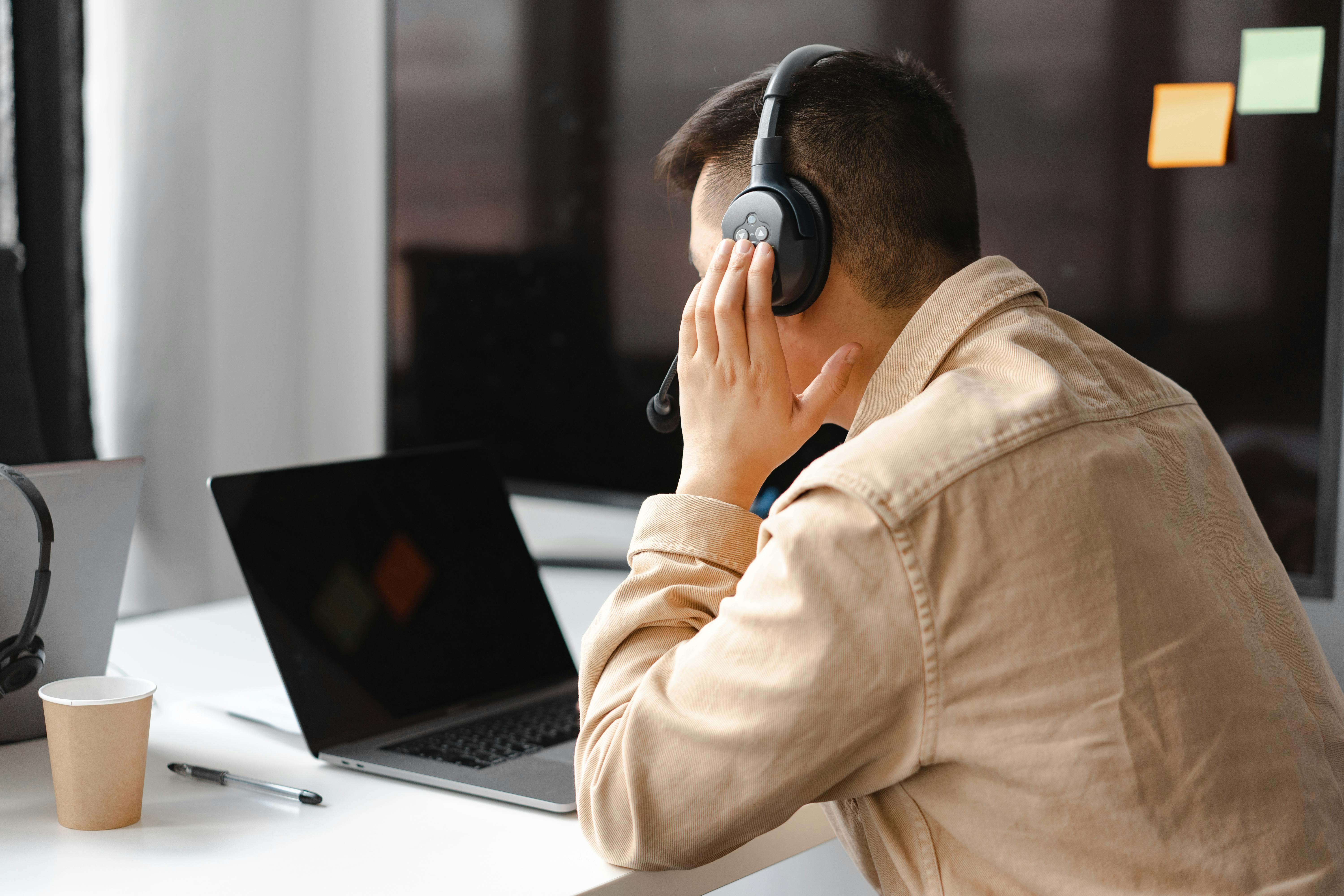 A UXresearcher testing his headphones before a recording
