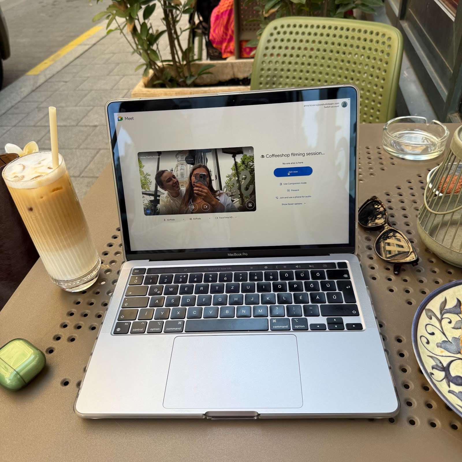 Copyfolio's two marketers working in a coffeeshop, ready to join a meeting and sipping on an iced latte.