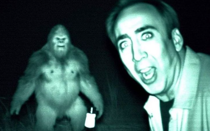 A nightvision photo of actor Nicholas Cage encountering Bigfoot. While Bigfoot is harder to take seriously, the deepfake of Nicholas Cage looks convincing, down to his bewildered expression.