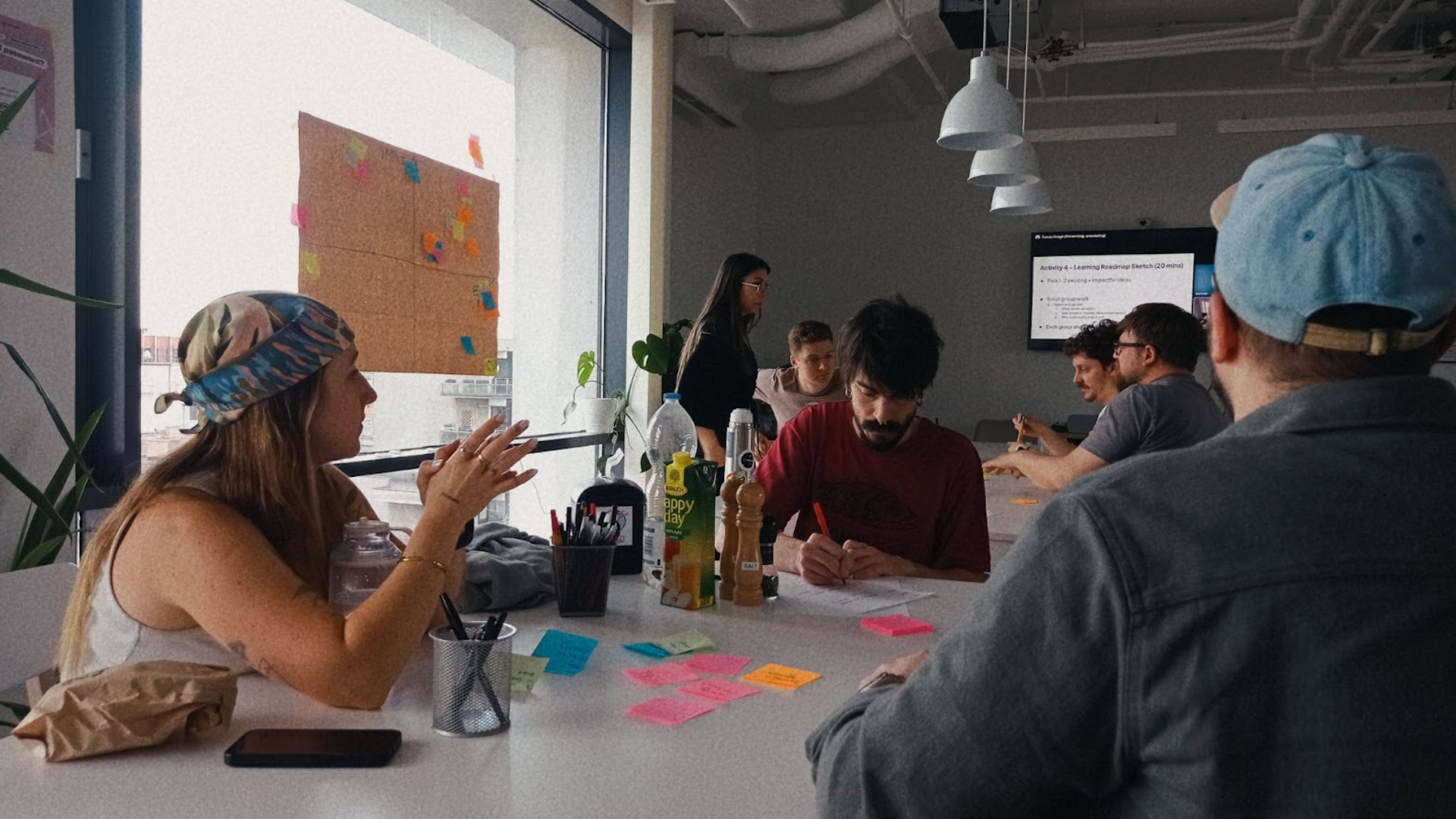 A photo taken at UX studio's office, showing designers writing on post-it notes