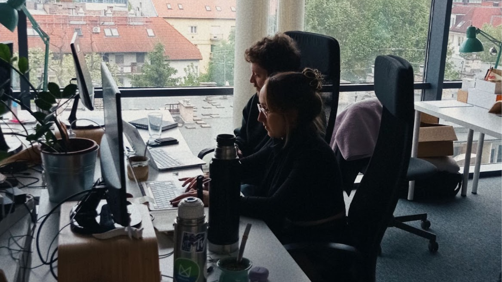 Designers working at their desk on a photo taken in UX studio