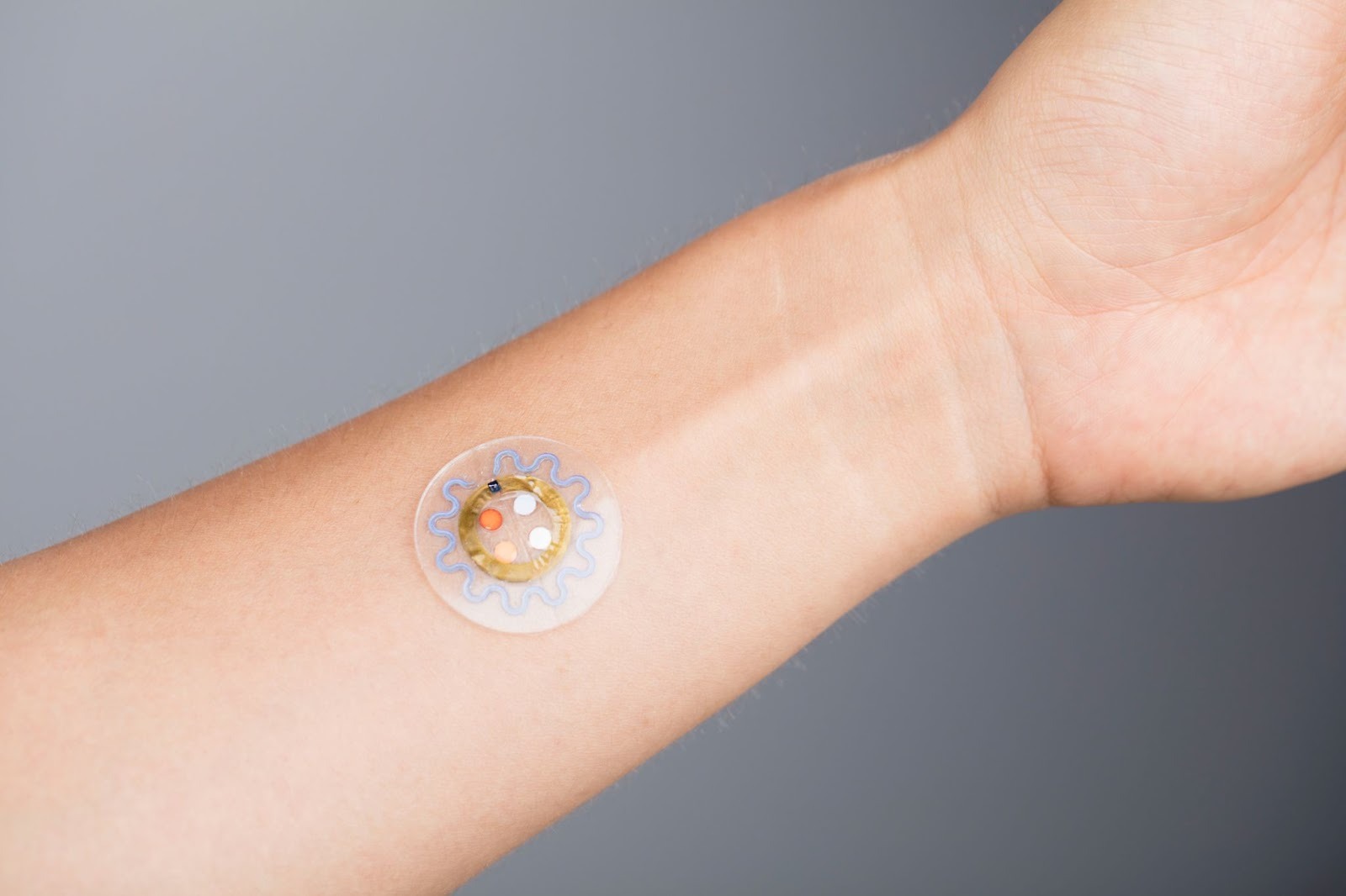 A microfluid patch is a smallish, round, transparent path that features a circle, a wiggle and four dots in varying shades from orange to white. The colors indicate changes.