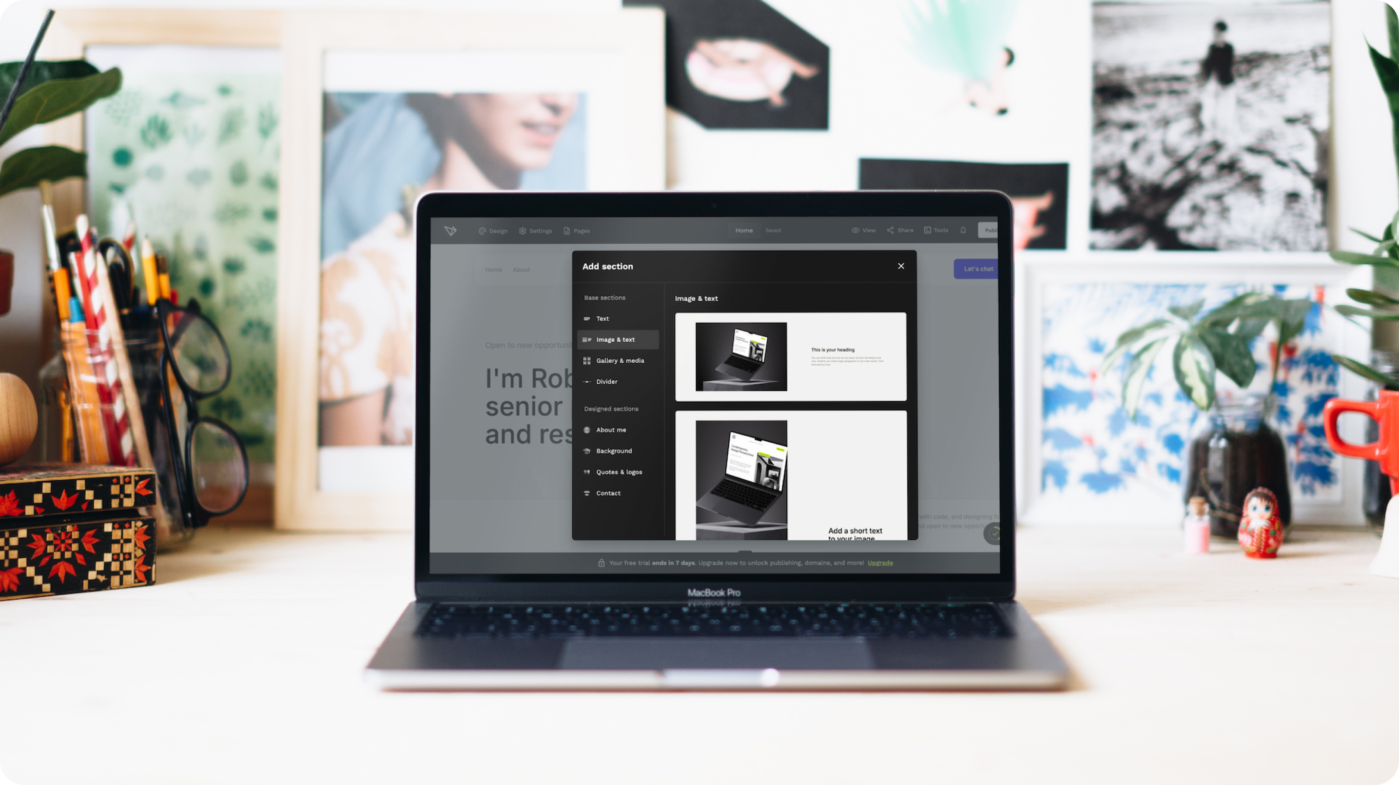 The image displays a workspace featuring a MacBook Pro positioned at the center, with its screen displaying a digital interface for a no-code portfolio builder. In the foreground, the interface shows options labeled "Add section" with two preview thumbnails of a laptop screen showcasing website layouts.
