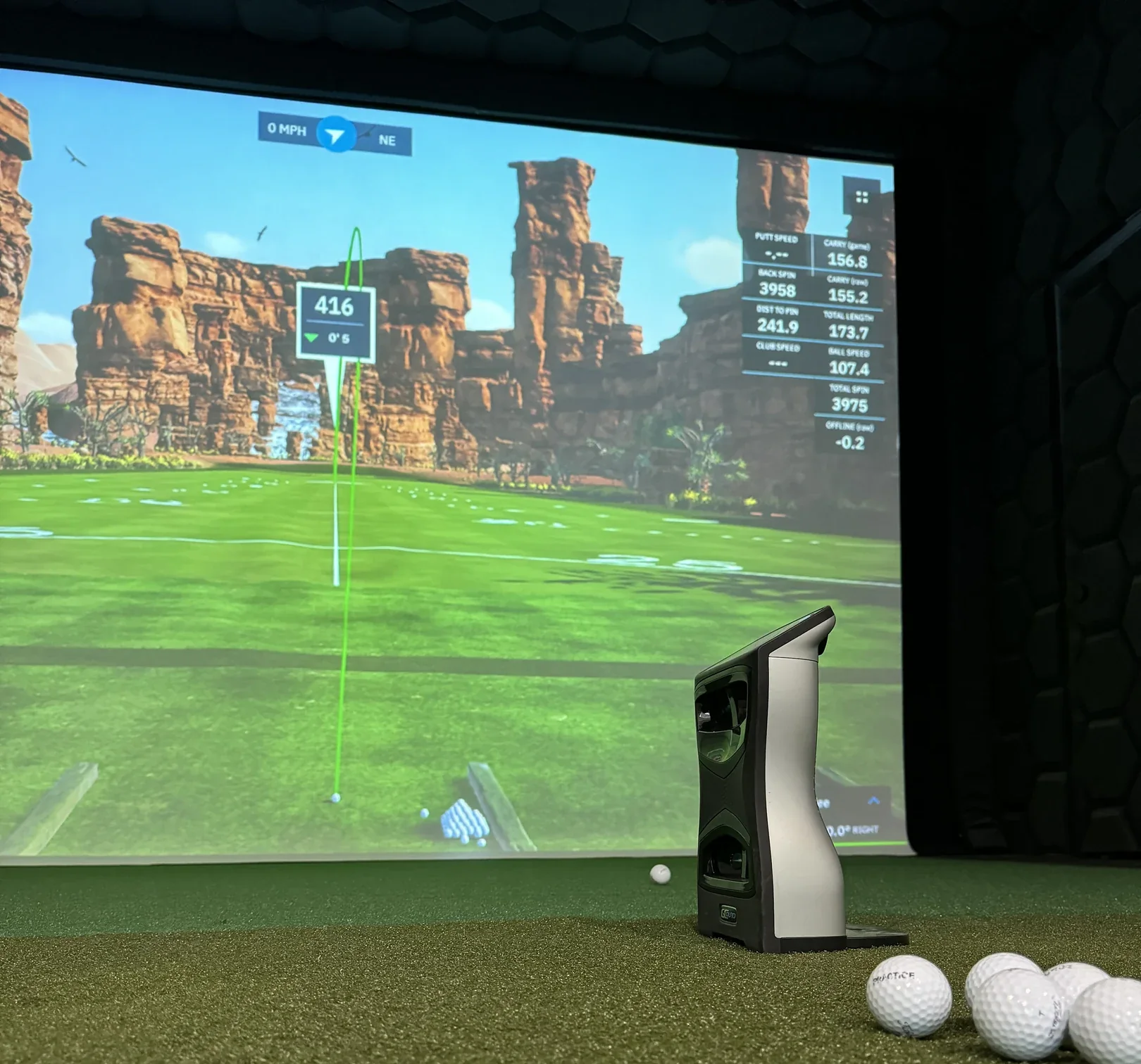 A launch monitor and GSPro on the screen at No. 1