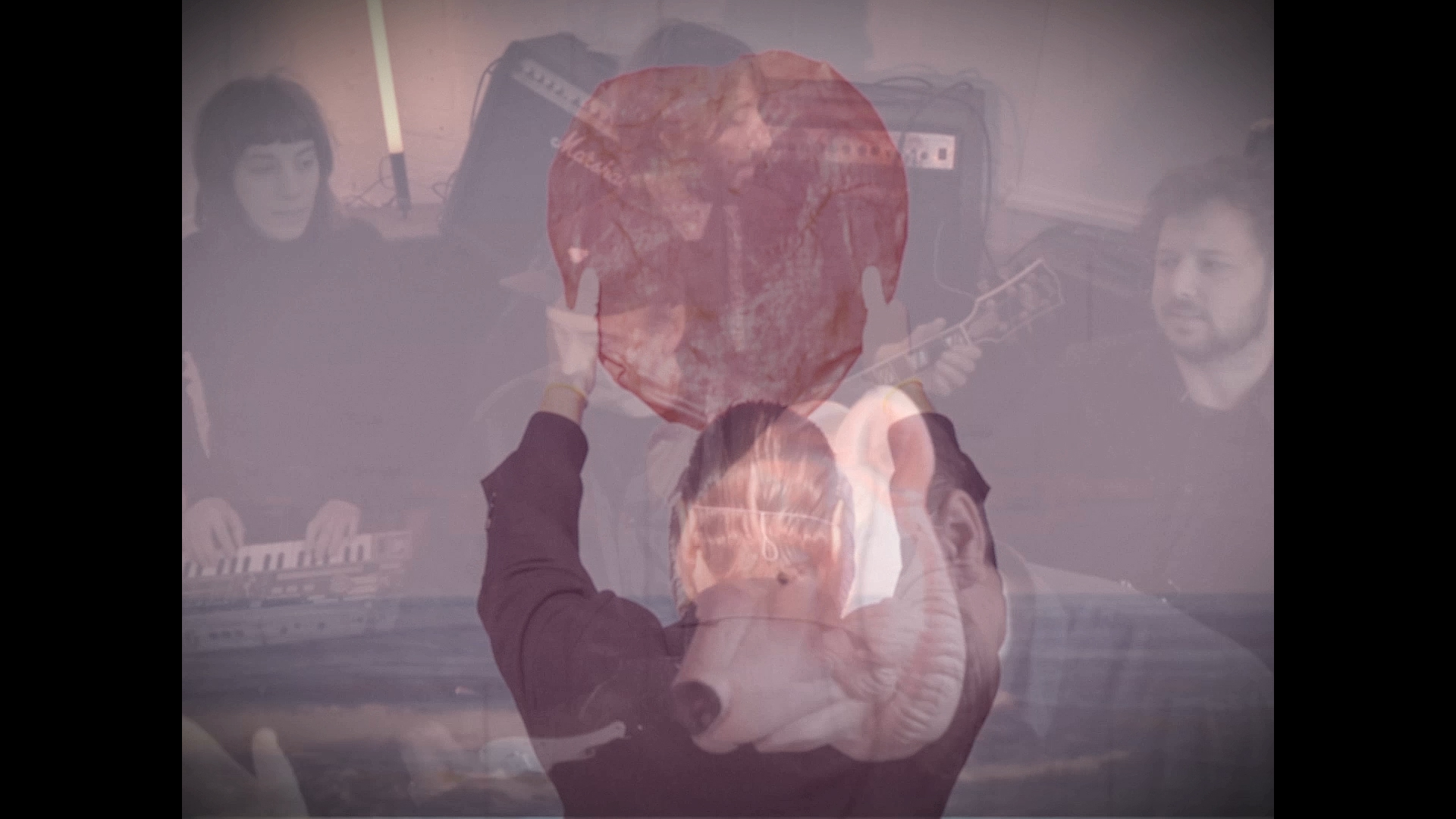 A snapshot of the videoclip from Poolnacht with the band, the sea and one of the band members dressed as a polar bear all blurred into one image.