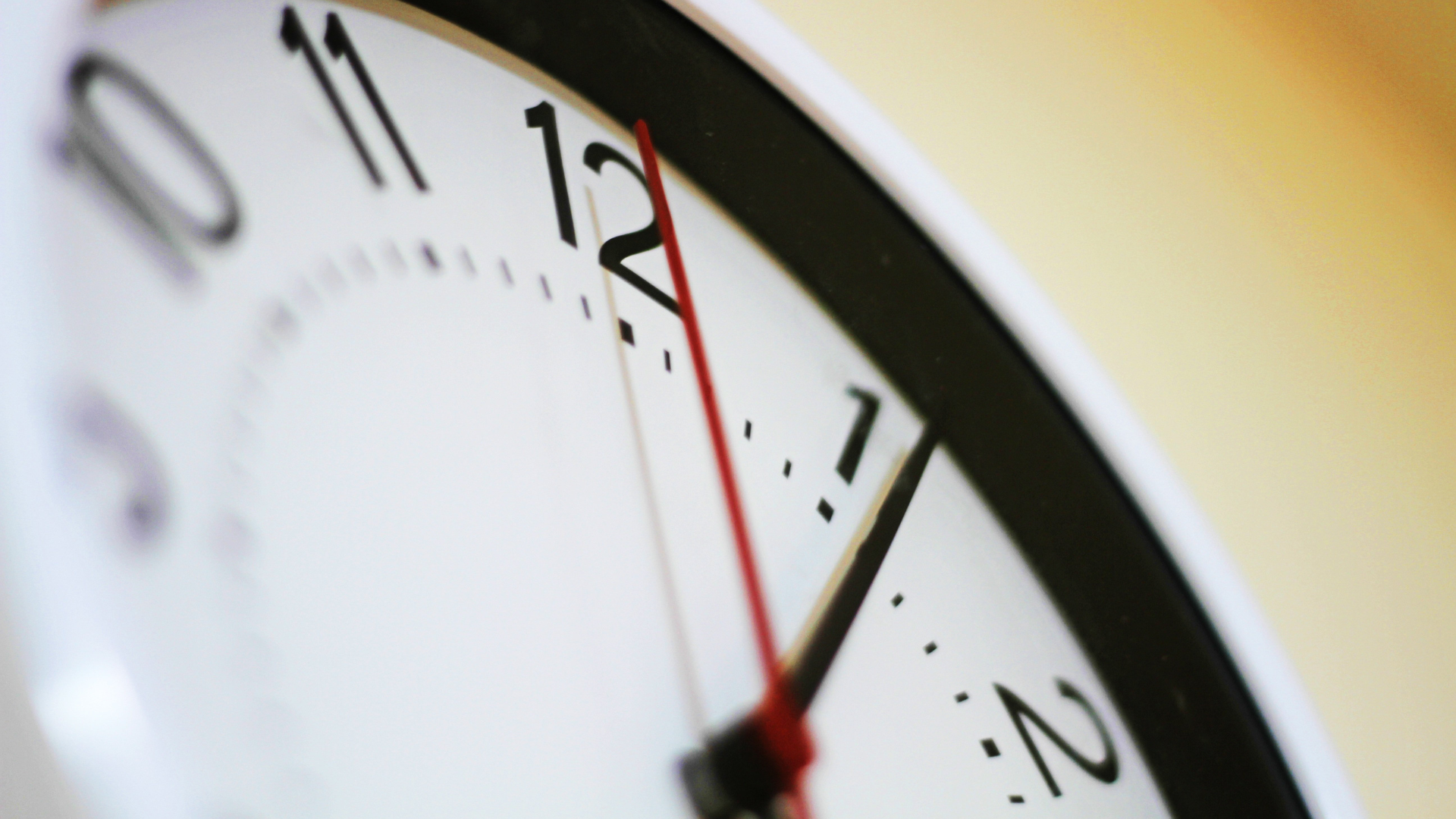 Bild zeigt eine Uhr vor gelbem Hintergrund