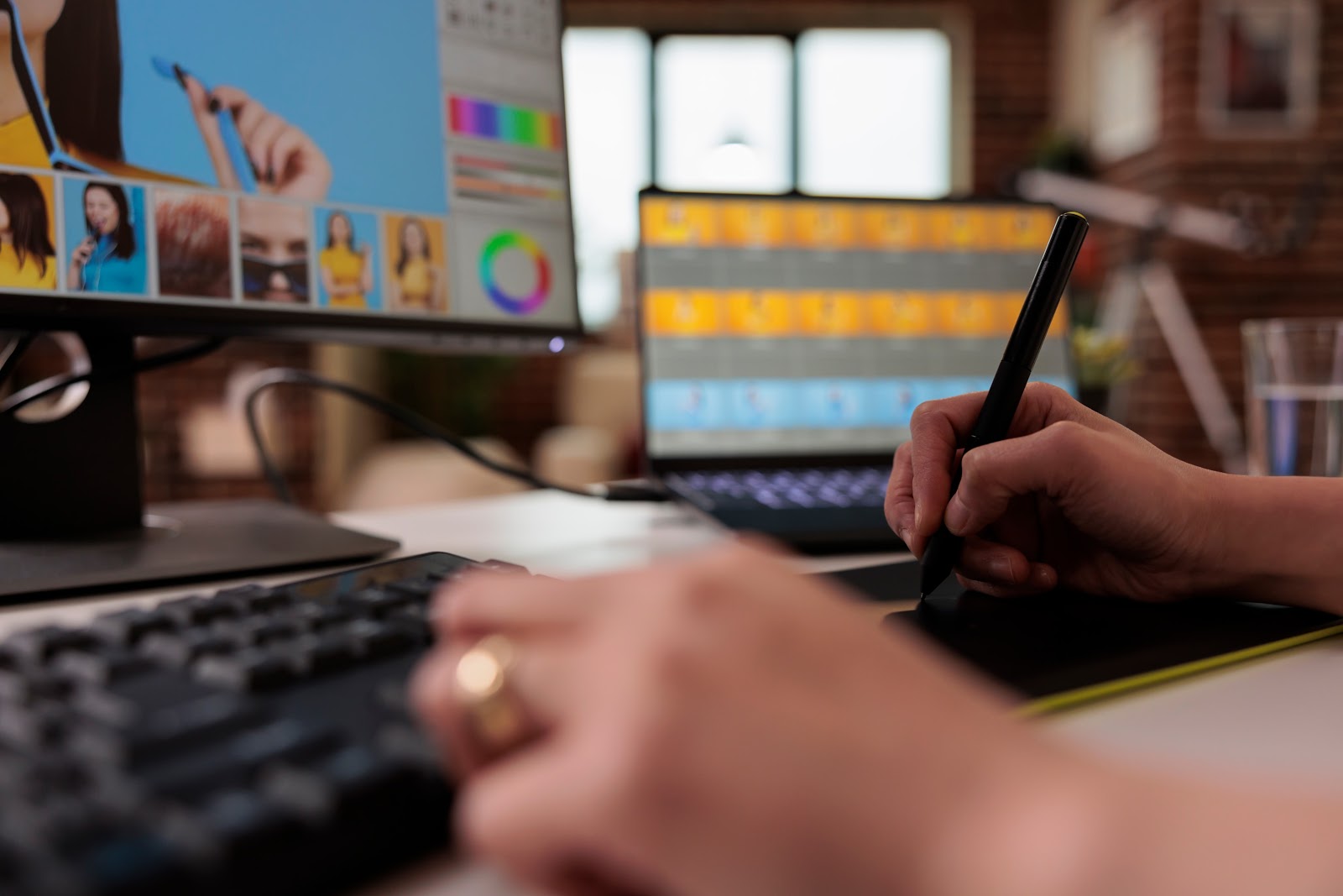 Female editor using stylus on graphic tablet to retouch photo