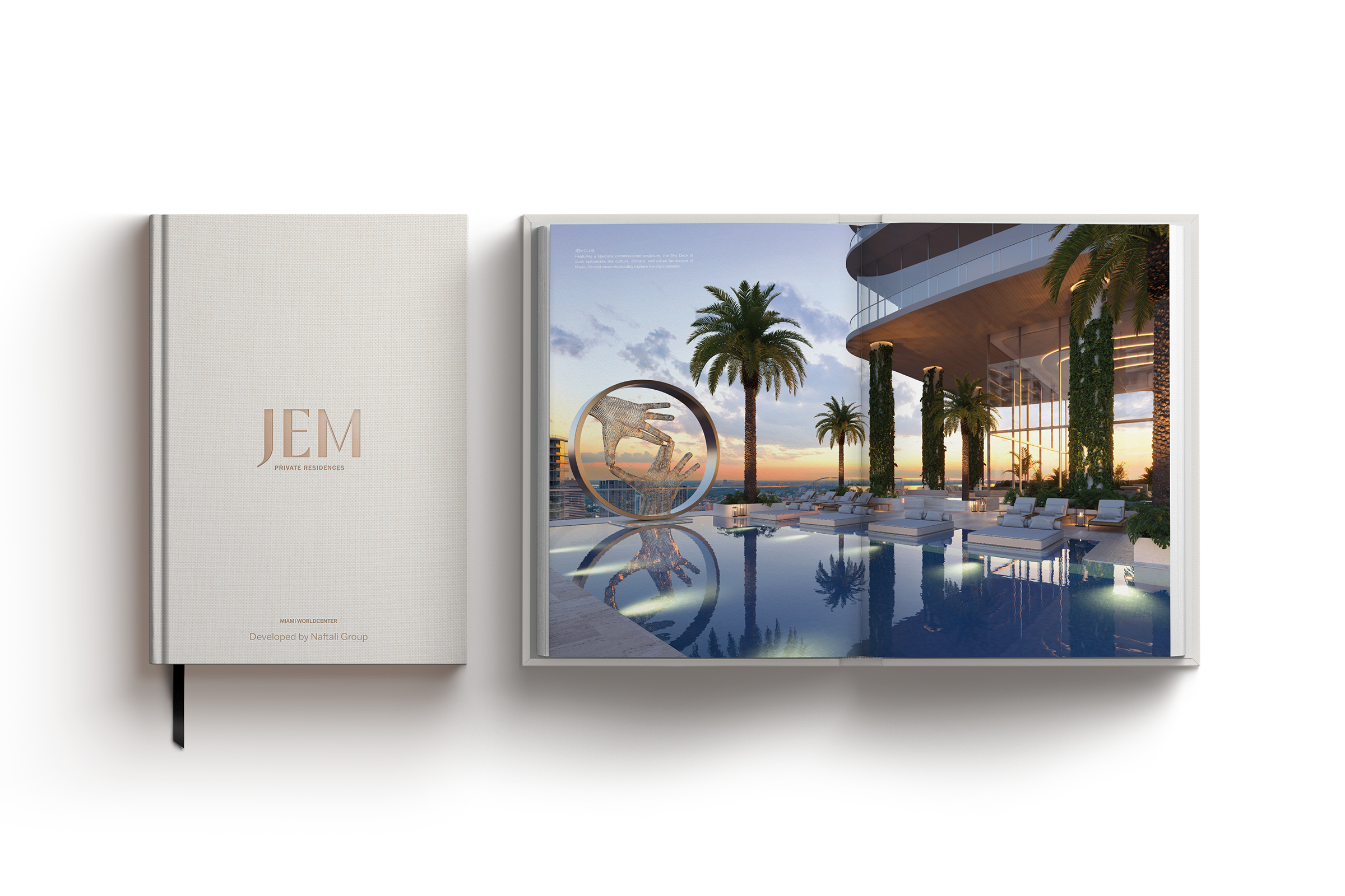 Open book showing a luxury poolside lounge area with palm trees, sunbeds, and a modern sculpture of two hands framed by a circular ring at sunset.