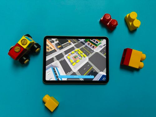 A photo of the game city park on a tablet around physical toys