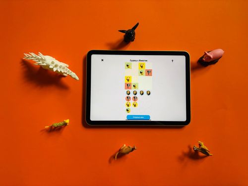 The game Animal Sudoku opened on a tablet device around physical animal toys
