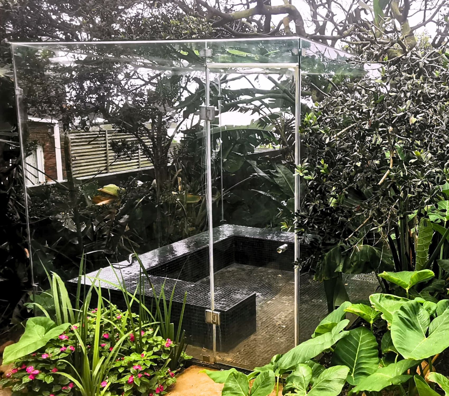 Custom steam room for commercial space with frameless glass doors built by Steam Sauna.
