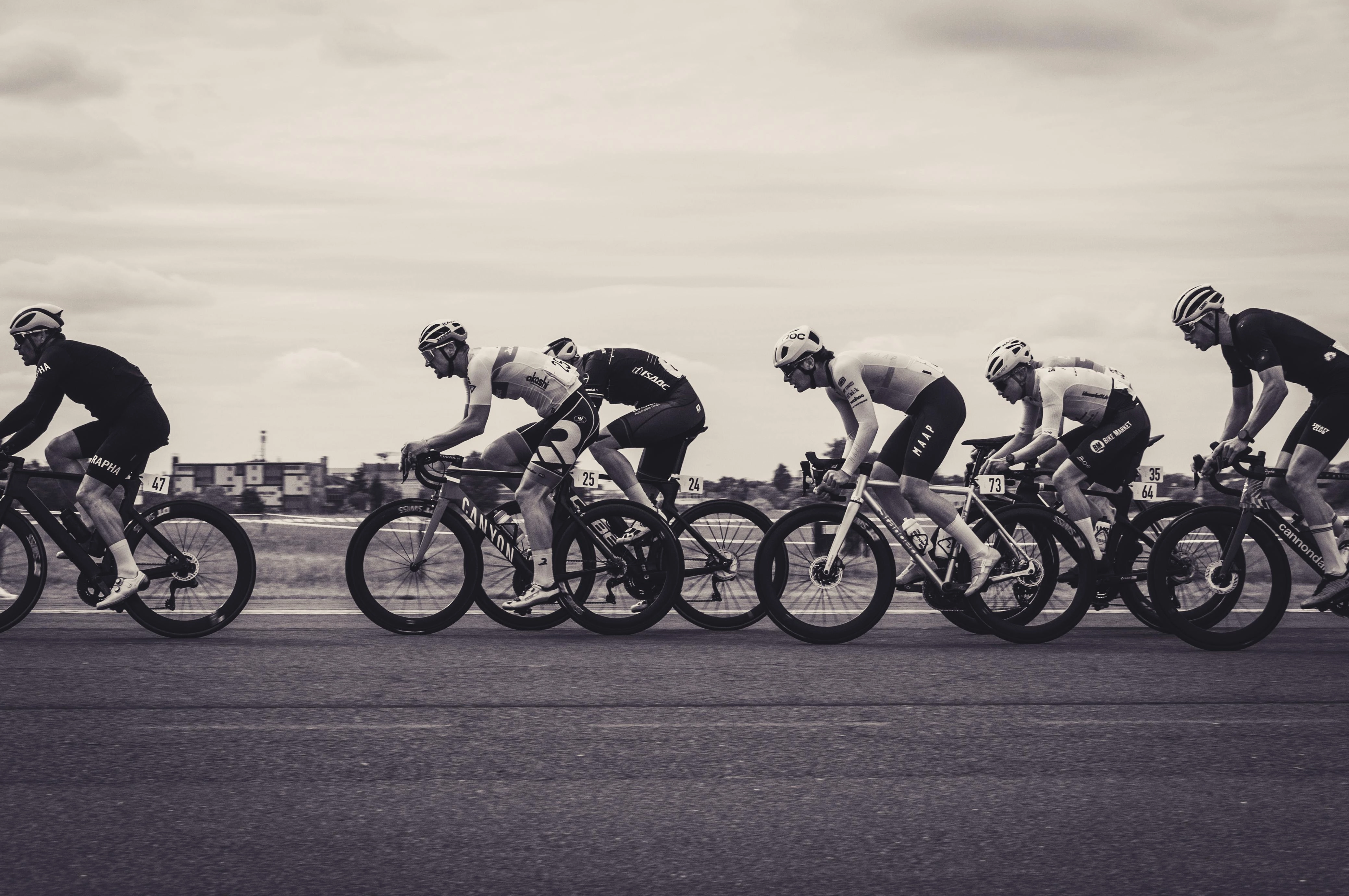Black and white image of cyclists racing