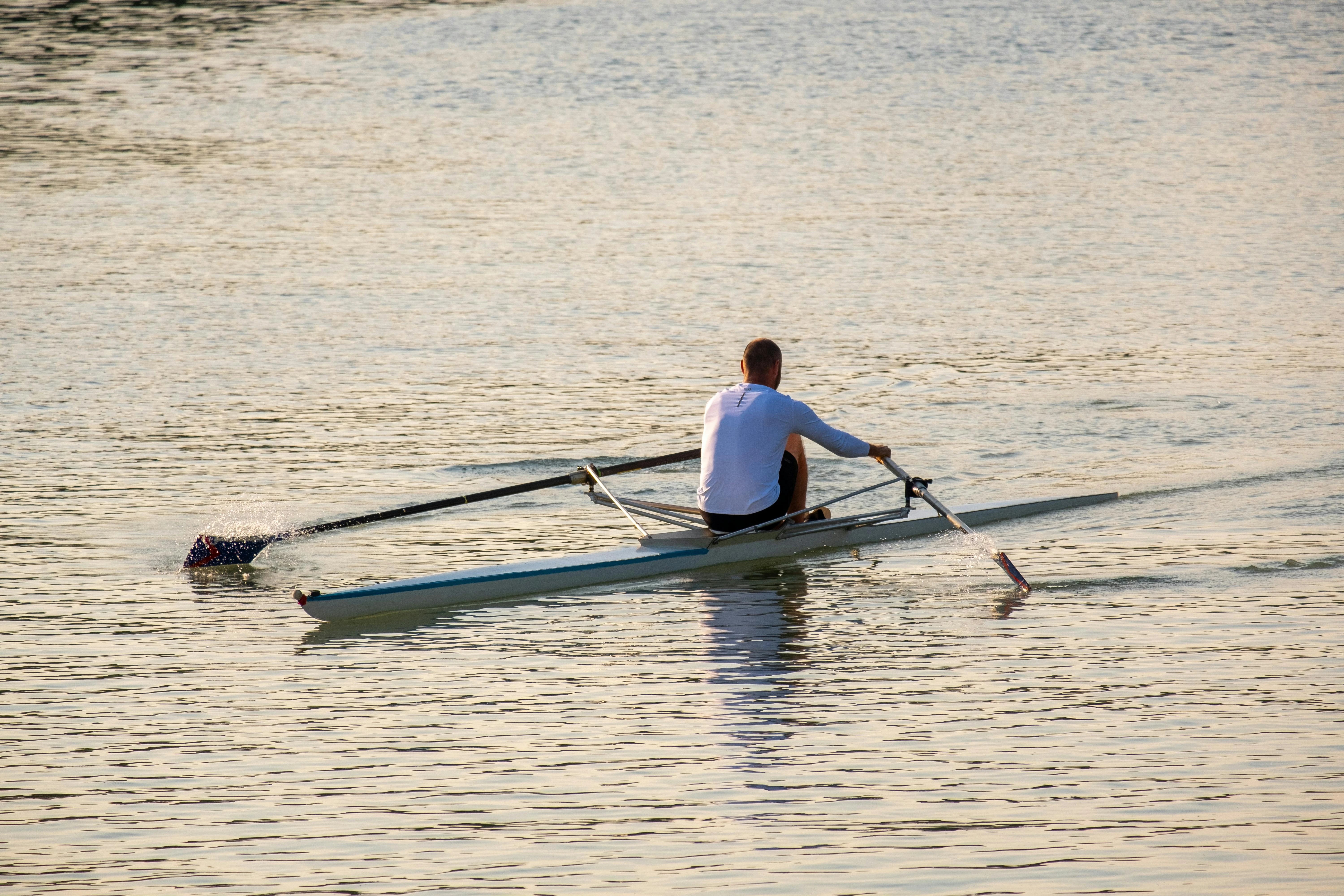 Man rowing solo on open water