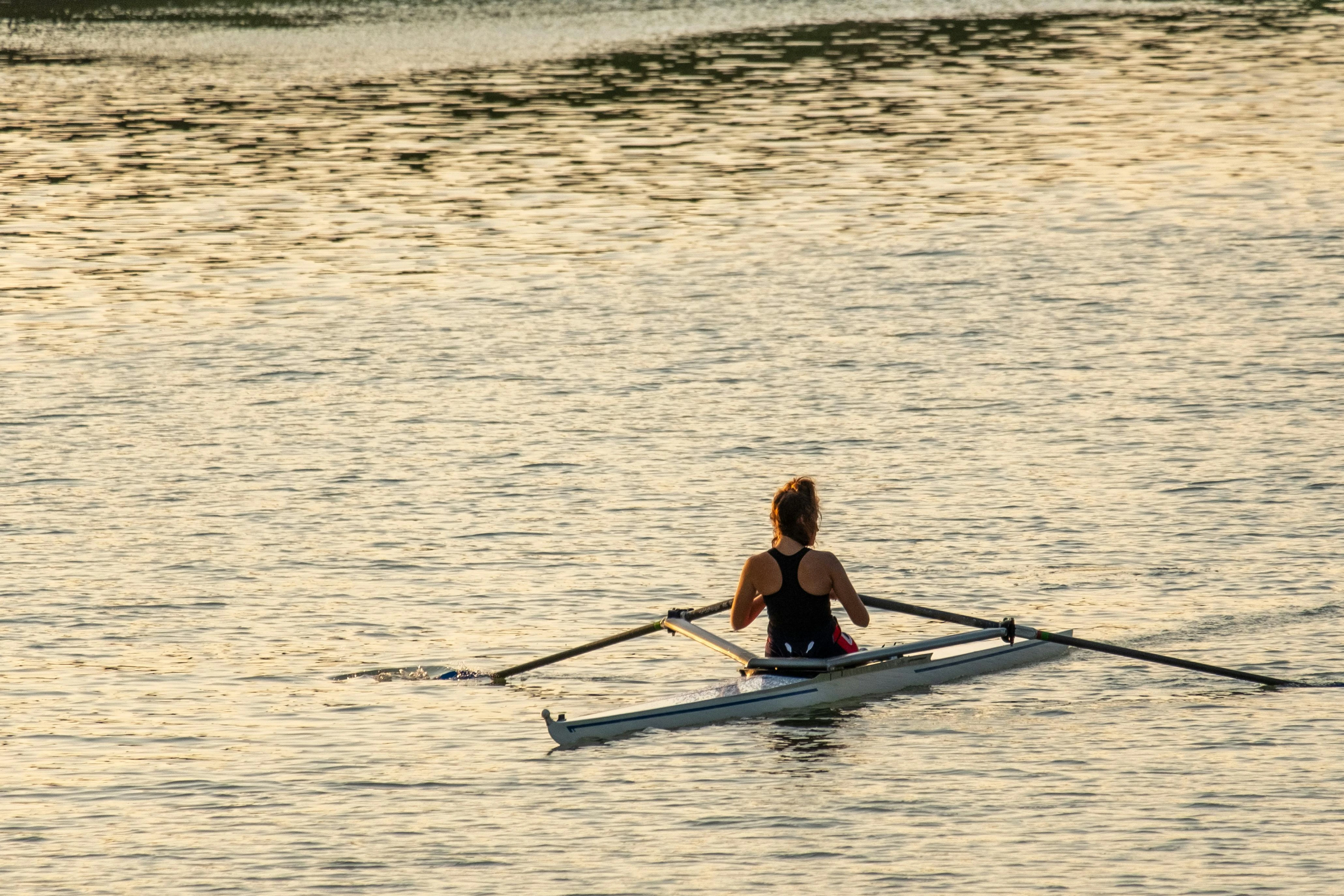 Woman rowing solo on the river