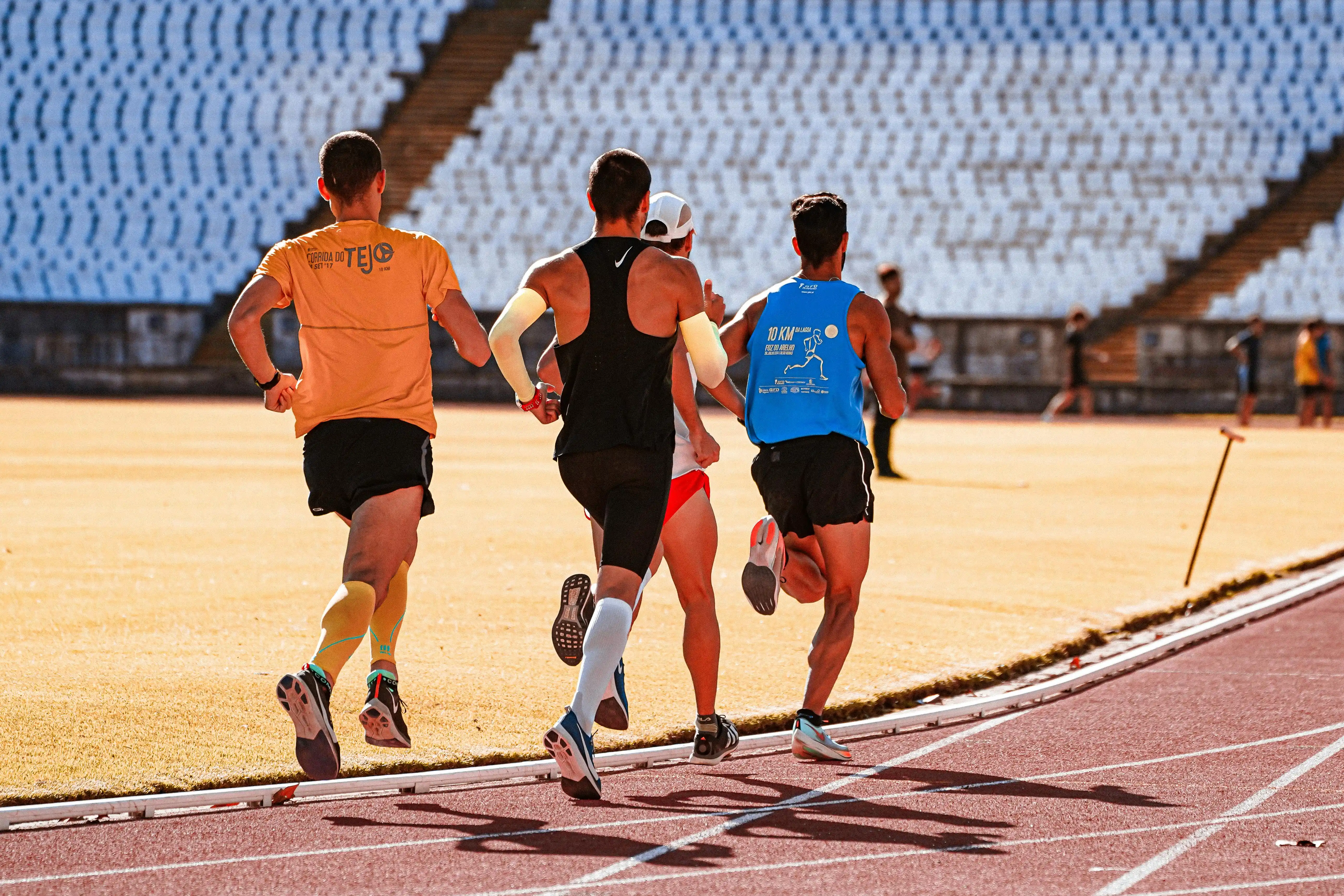 Group of men running on a track