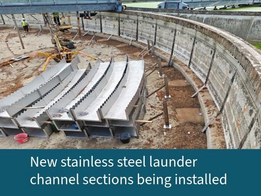New stainless steel launder channel sections being installed