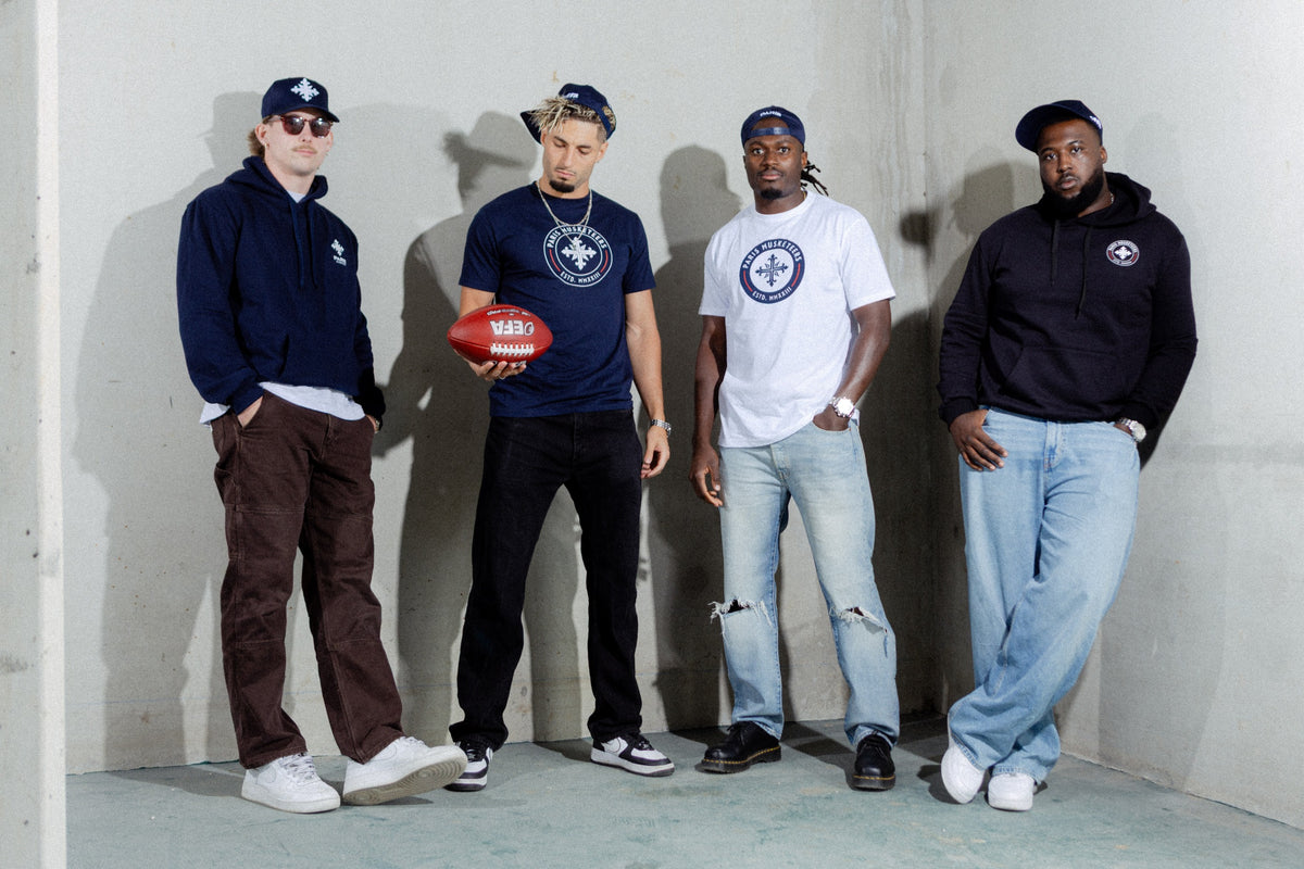 Musketeers players wearing official club caps, T-shirts, and hoodies
