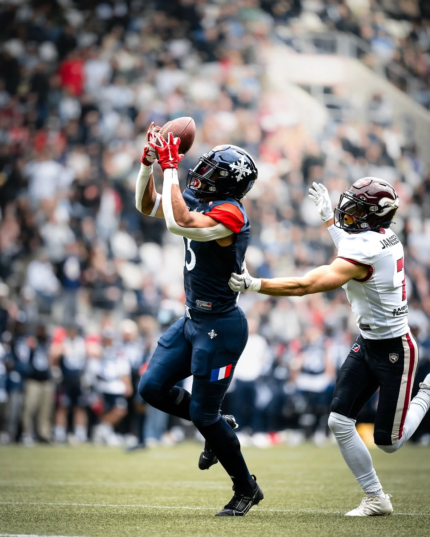 A Paris Musketeers receiver contesting a catch during a game