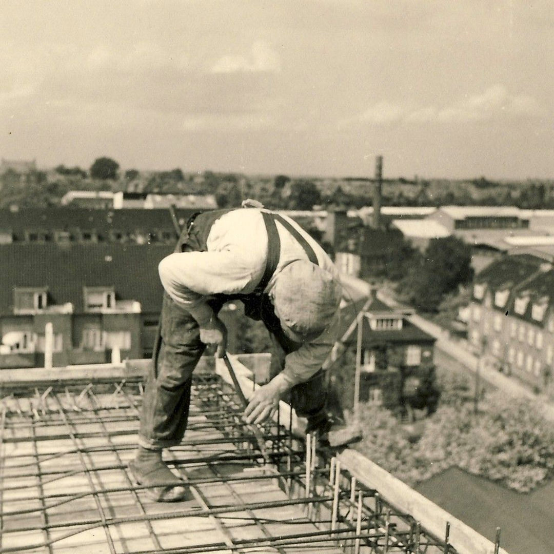 Man wearing clogs while working with rebar. 