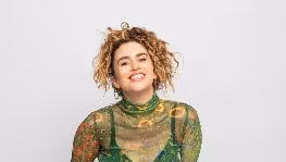 A person smiling at cameraDescription automatically generated