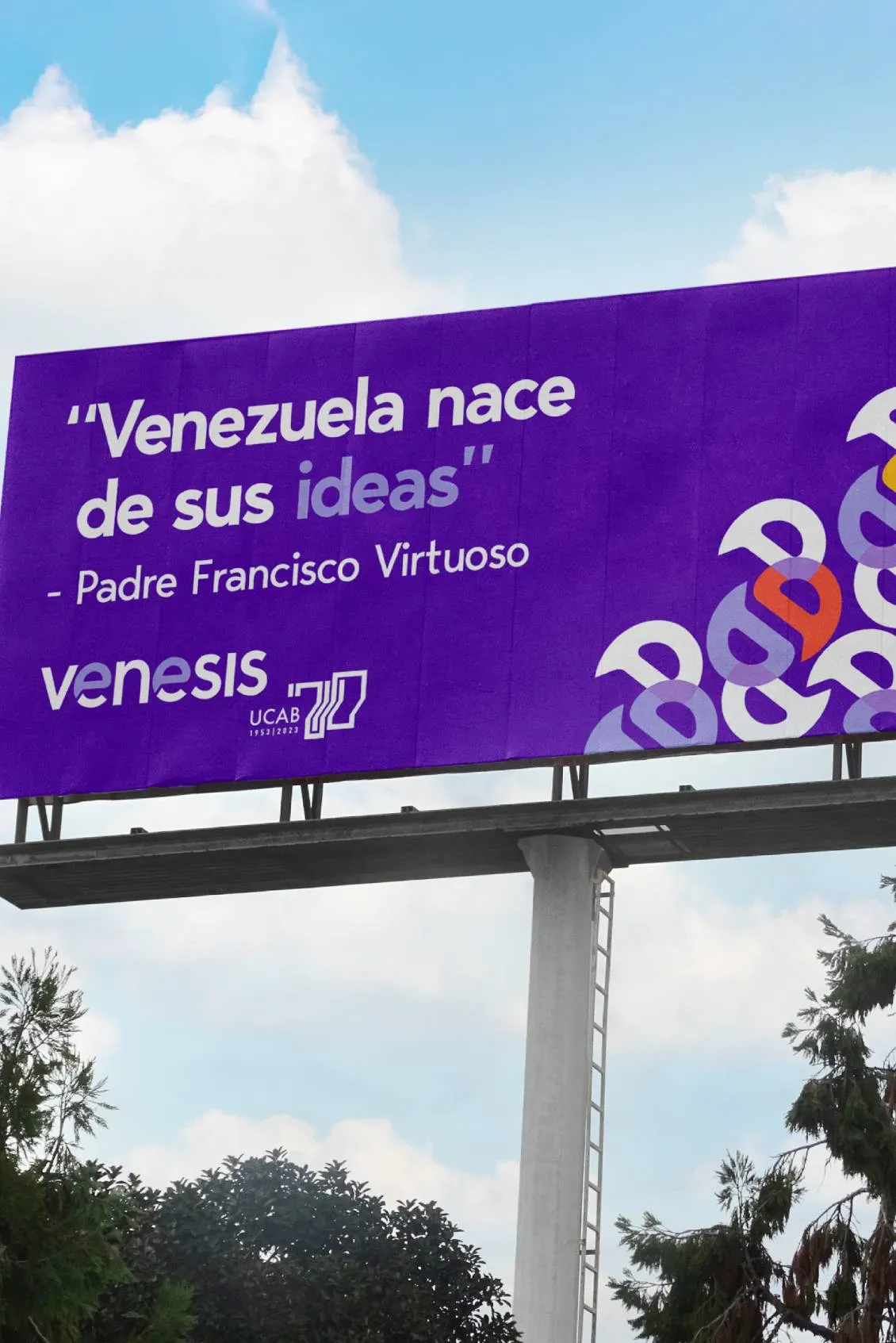 Purple billboard with the quote 'Venezuela nace de sus ideas' by Padre Francisco Virtuoso, along with venesis and UCAB 70 logos.
