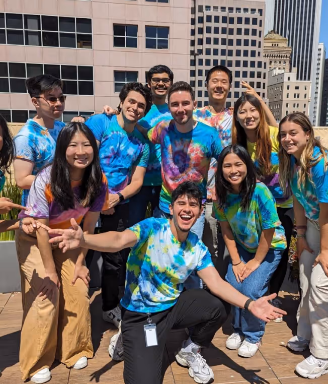 A group of sigma employees in bright shirts
