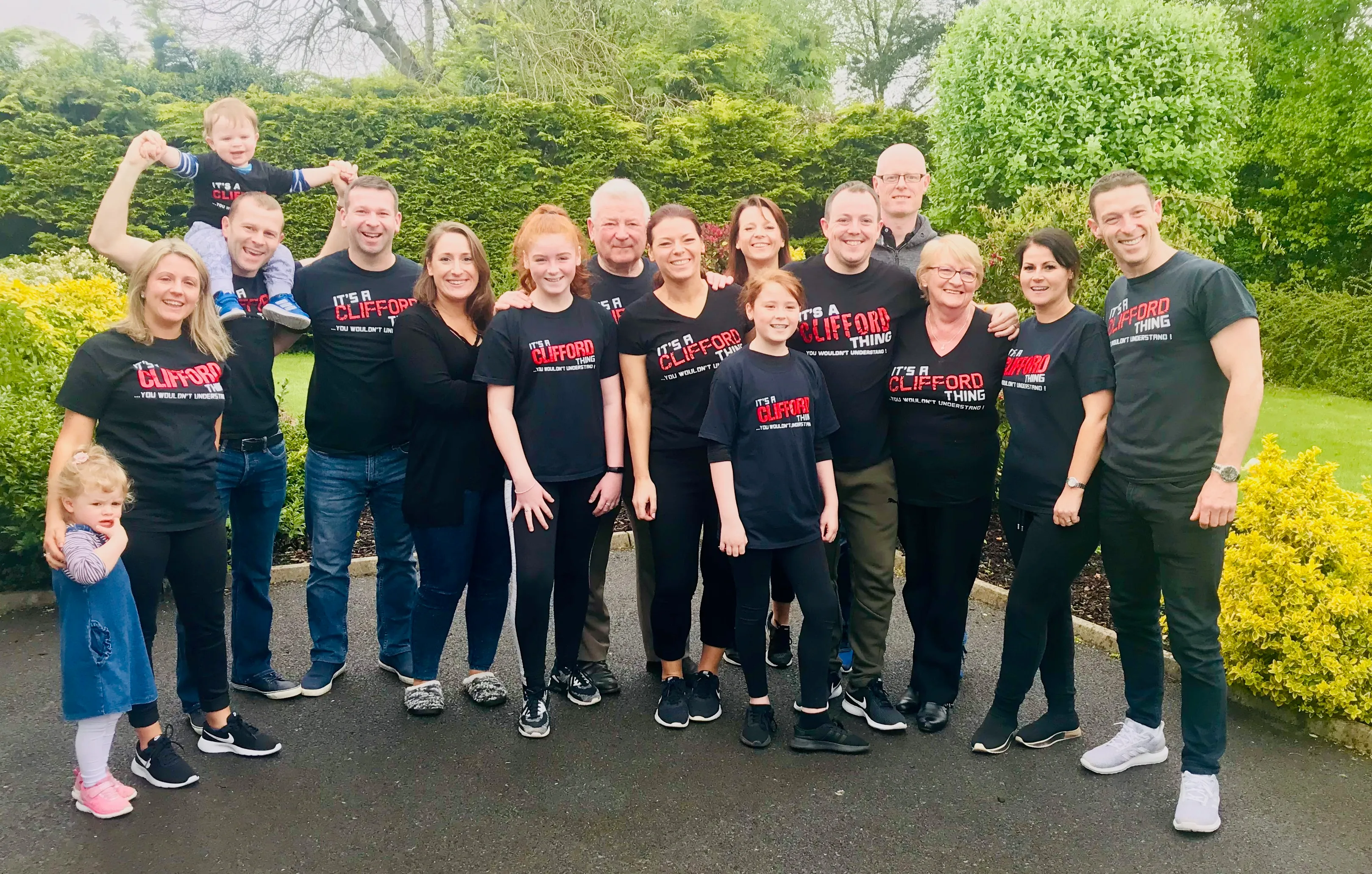 A group of people wearing black shirts and posing for a picture.