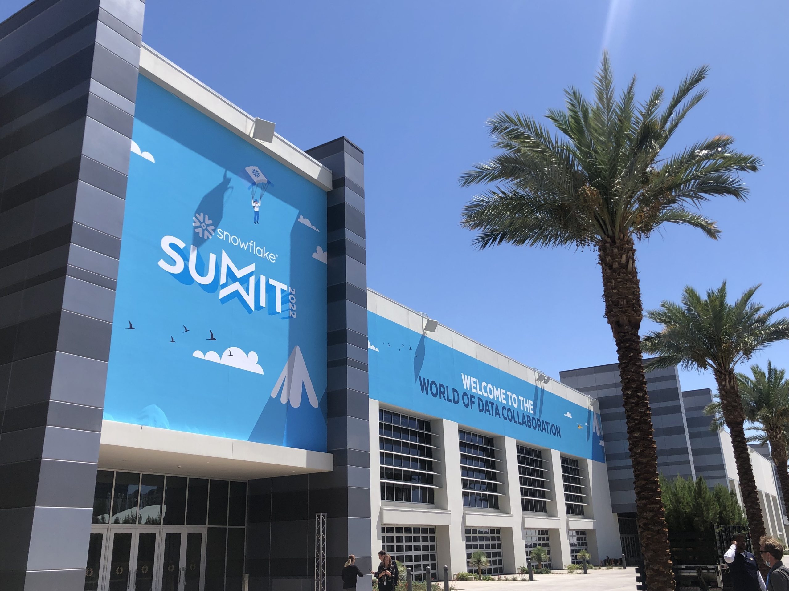 A large blue sign with a white arrow pointing upwards and the words 