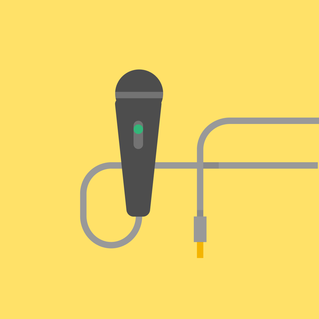 Gray microphone with a green switch and attached cable on a yellow background.