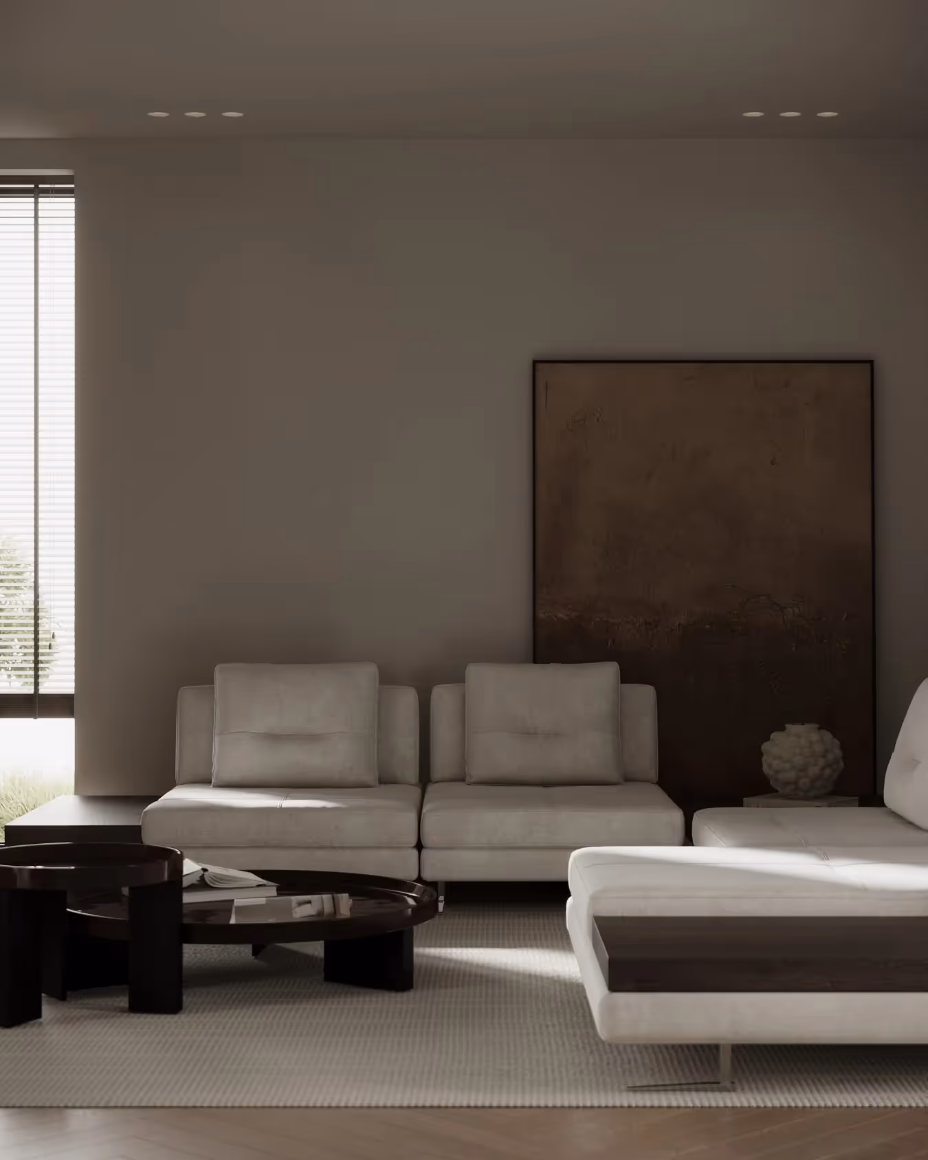 A living room with a white couch and a black table.