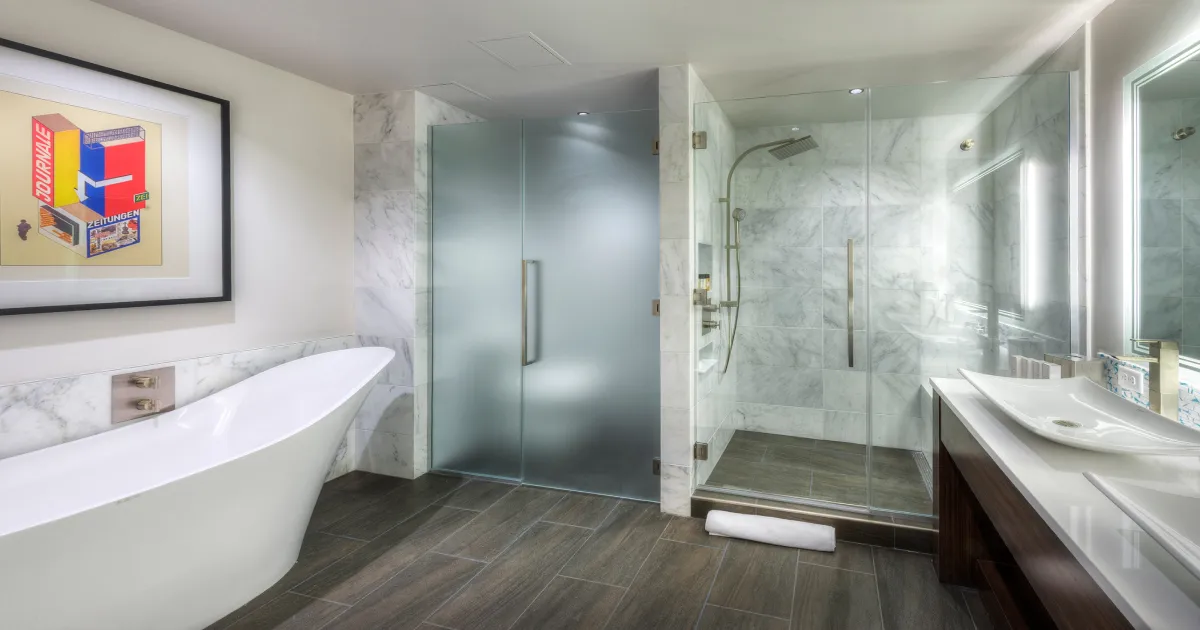 A bathroom with a tub, sink, and shower.