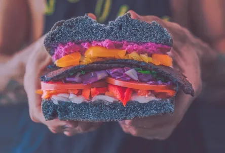A person holding a burger
