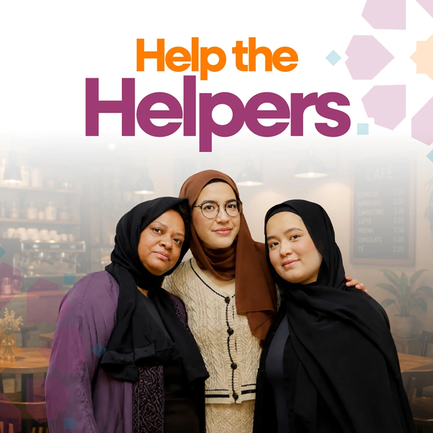 A promotional graphic featuring three women wearing hijabs posing closely together inside a warm cafe setting, with the title "Help the Helpers" displayed above them.