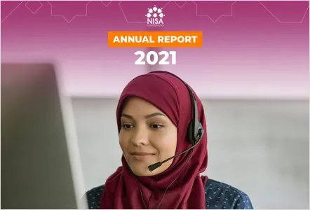 A woman wearing a maroon hijab and a headset looks at a computer screen, set against a pink background featuring the Nisa Foundation logo and the text "ANNUAL REPORT 2021."