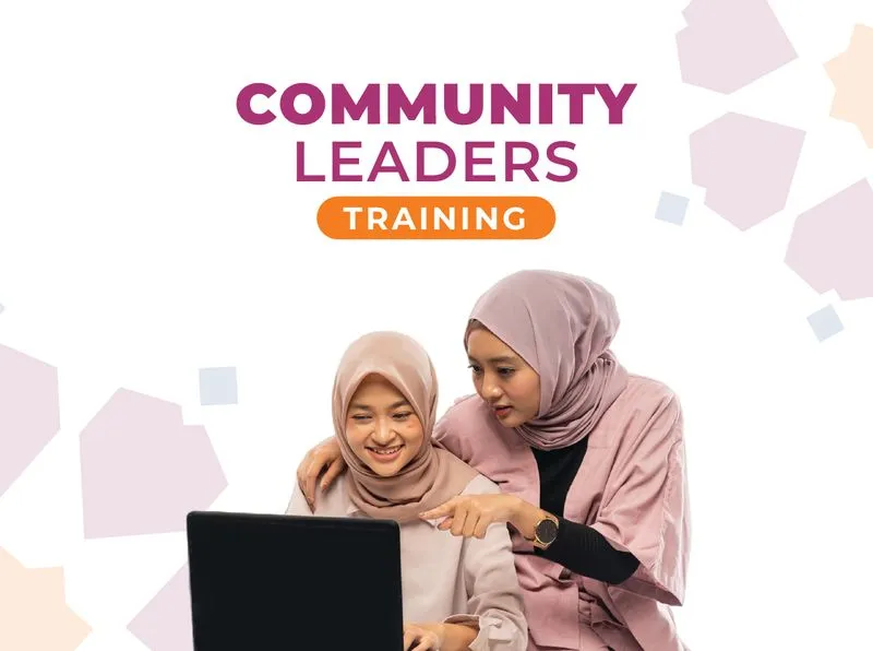 Two women wearing hijabs look at a laptop screen together, with one pointing at the display. Above them, the text reads "COMMUNITY LEADERS TRAINING" against a white background with abstract geometric shapes.