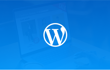WordPress logo centered over a blurred laptop screen with a website page in the background.