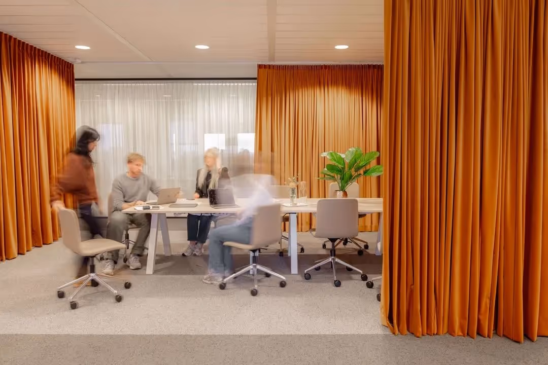 Hybrid office layout redesign showing zoned workspace for hot desking collaboration and breakout areas