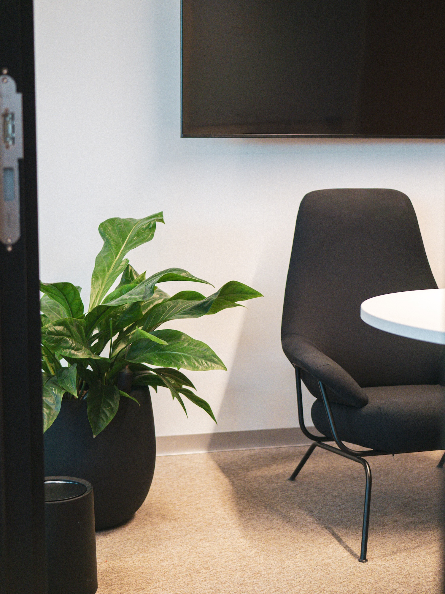 NORNORM lounge chair and round table in a quiet corner of Hive's Berlin office