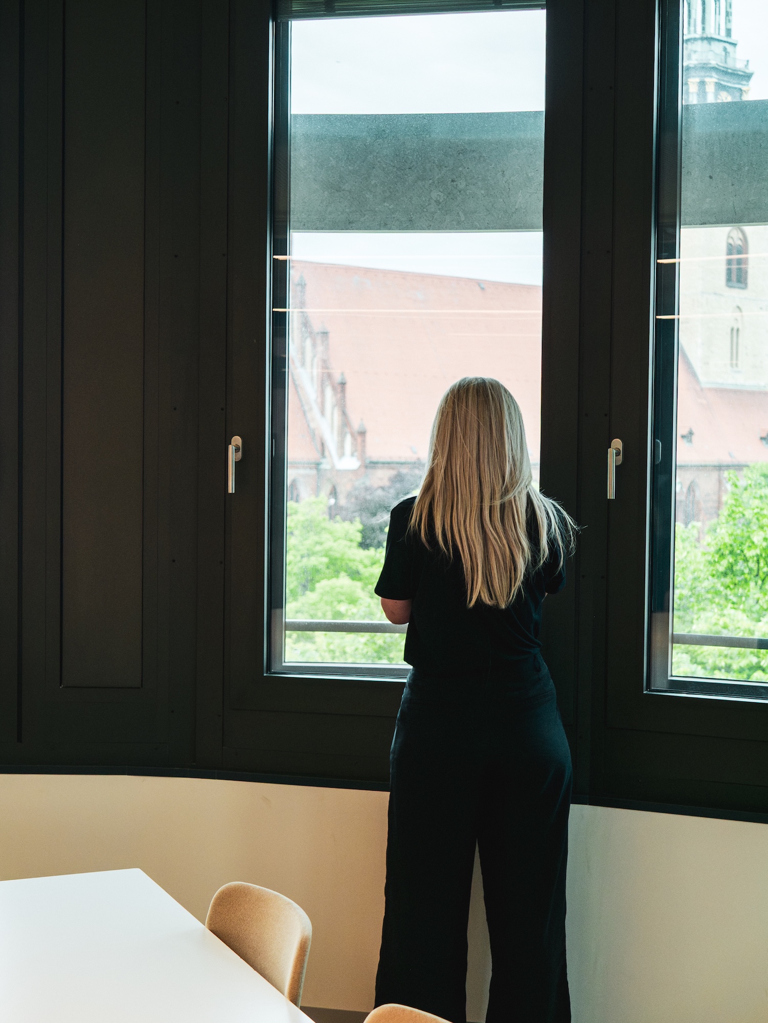 Hive employee looking out over Berlin's rooftops from the office window