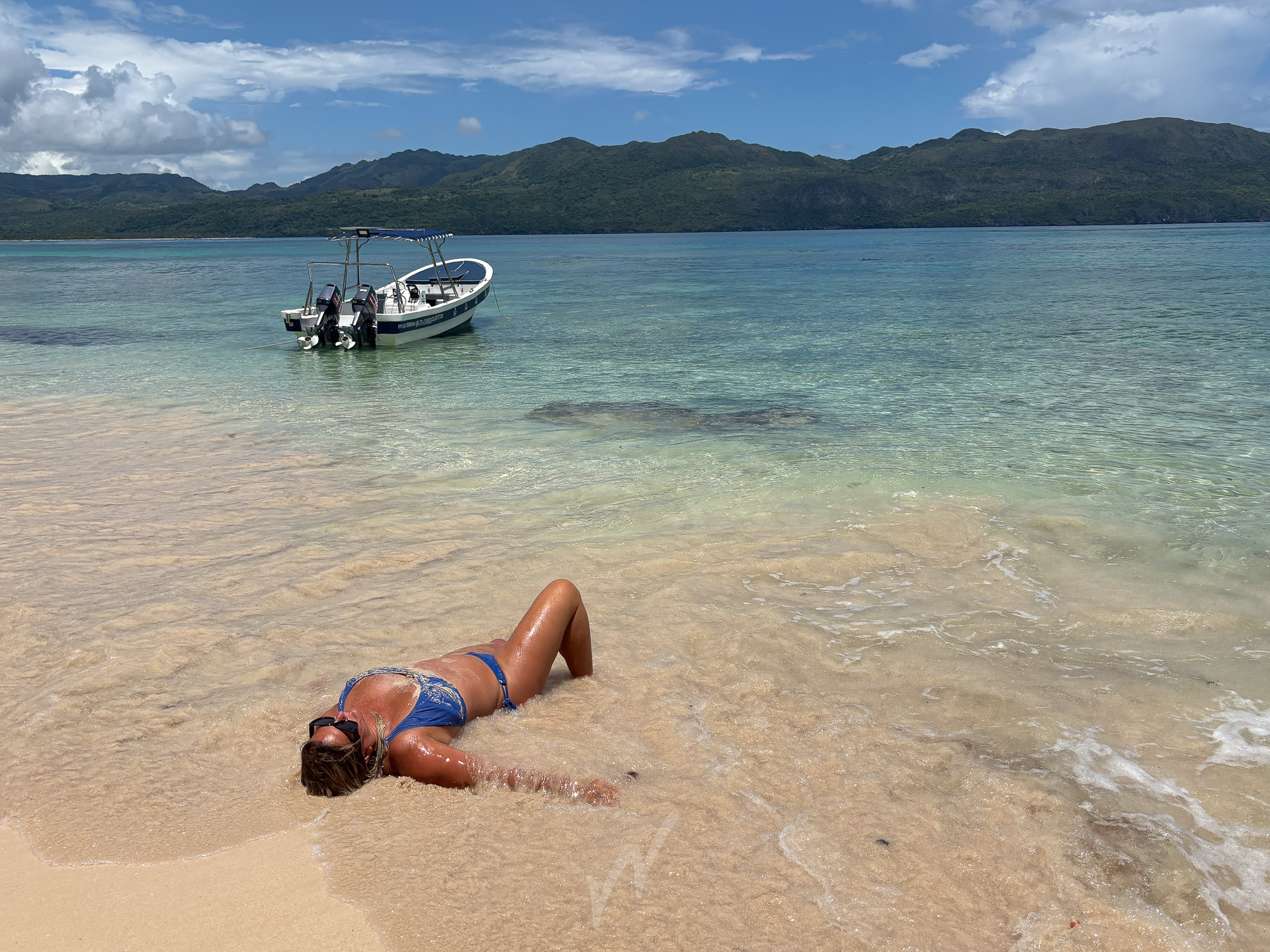 Jolie Playa boat anchored near a secluded beach in the Dominican Republic